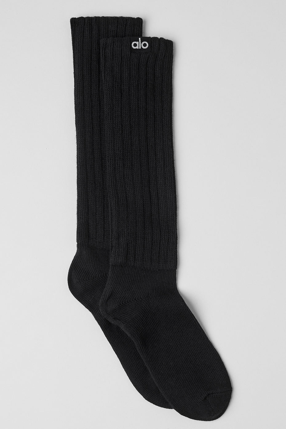 Close-up of black scrunch socks with layered leg scrunches and breathable fabric