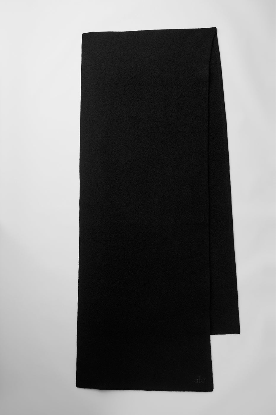 Black merino wool oversized scarf draped stylishly over a coat.