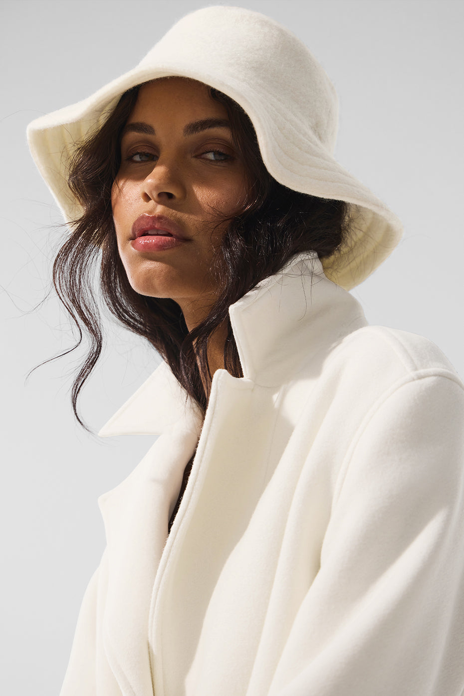 Front view of ivory merino wool bucket hat on a snowy day.