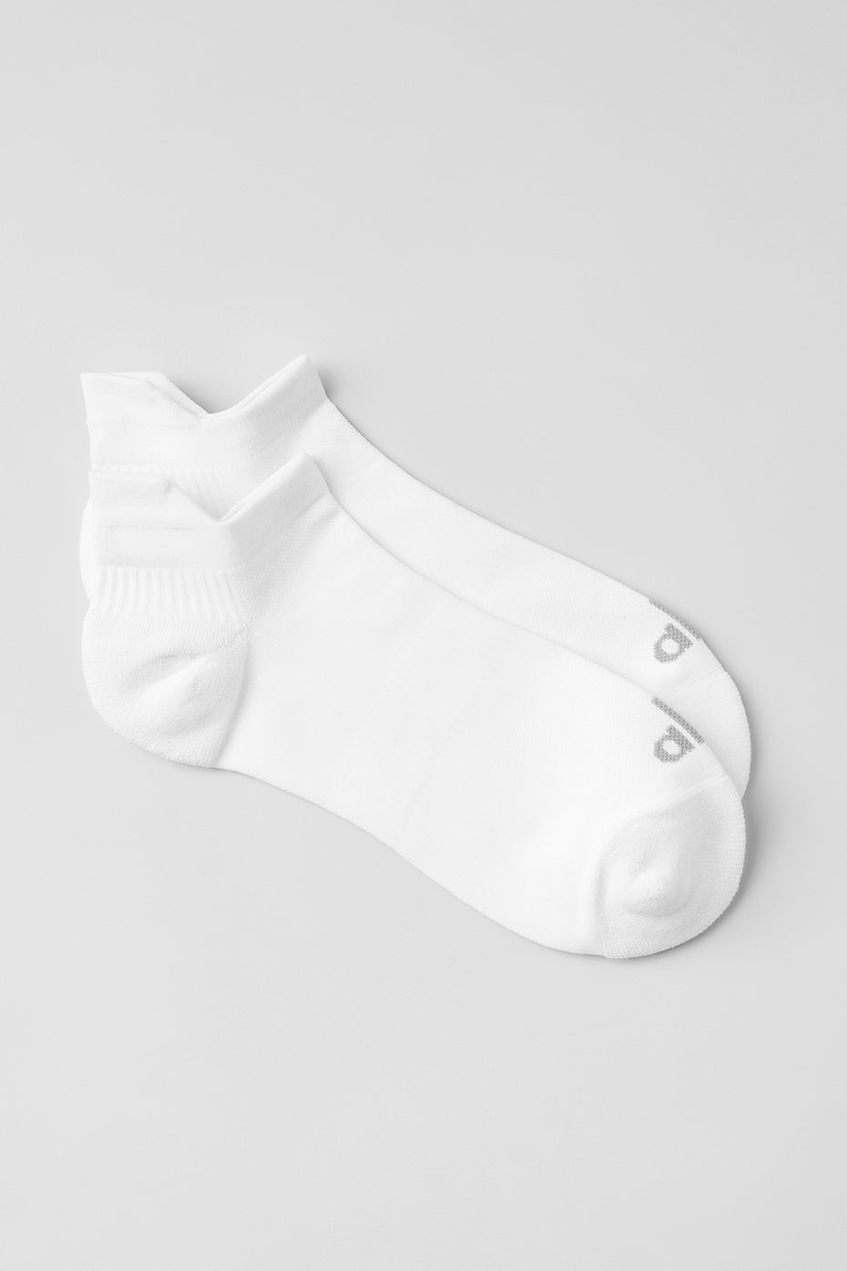 Wellow compression socks for men shown in a runner's stride