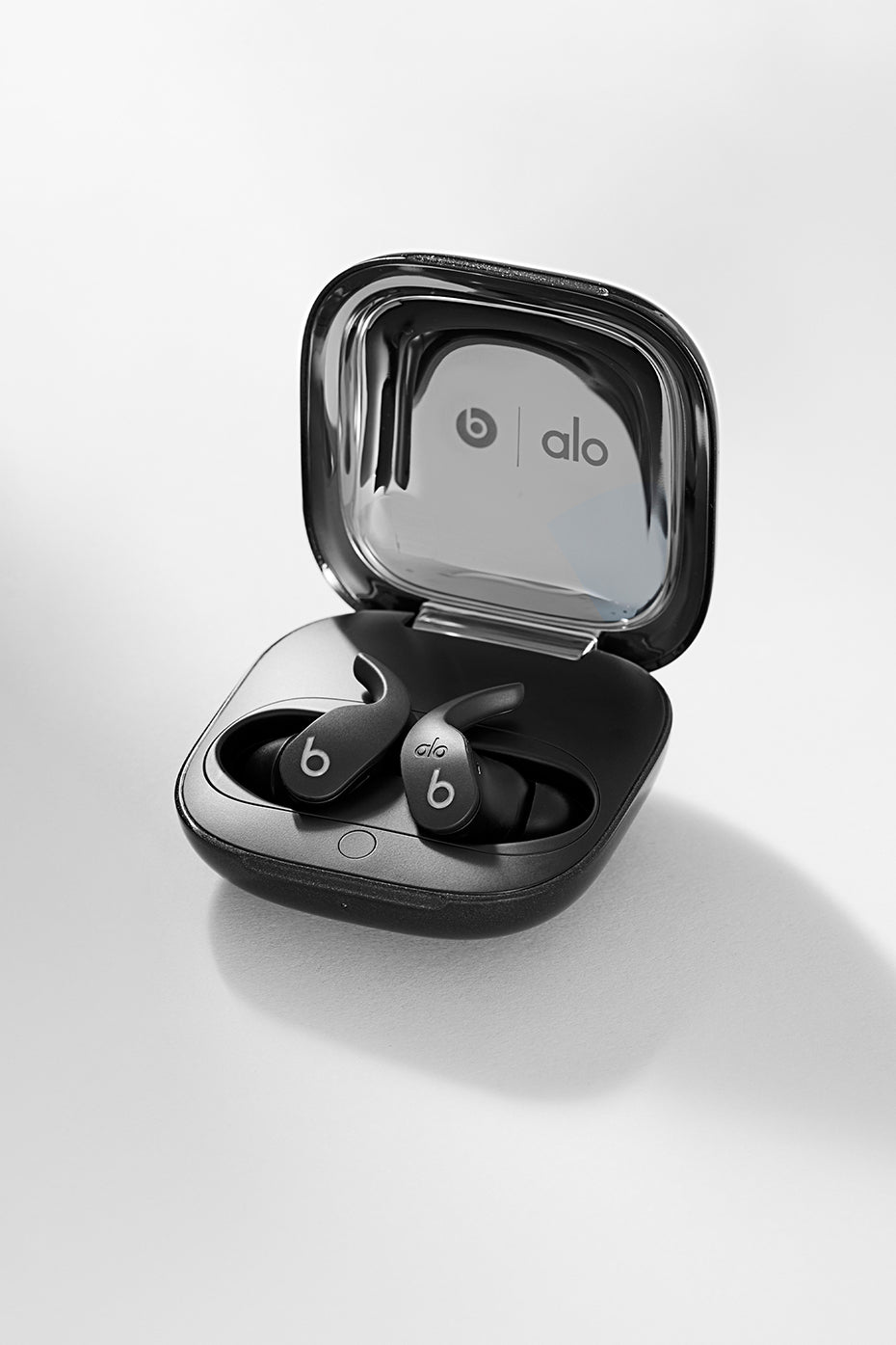 Close-up of wireless earbuds highlighting chrome finish and ergonomic tips