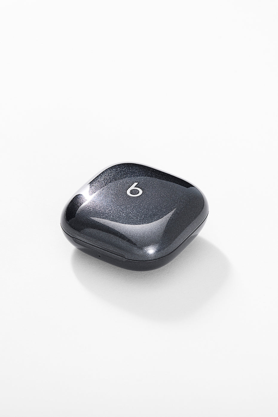 Detail shot of true wireless earbuds resting on gym towel after workout