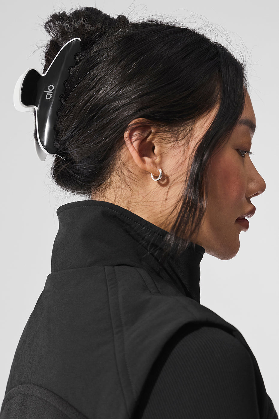 Black and white claw clip with contrasting outline holding hair in a stylish updo