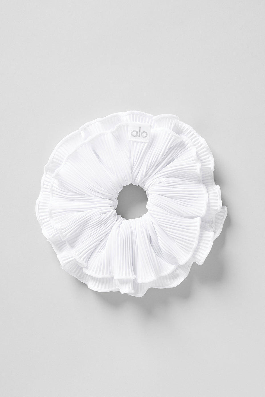 Close-up of oversized silk scrunchie in white, showcasing its smooth texture.