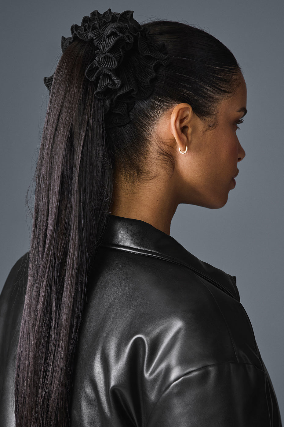 Close-up of oversized black scrunchie on a ponytail.