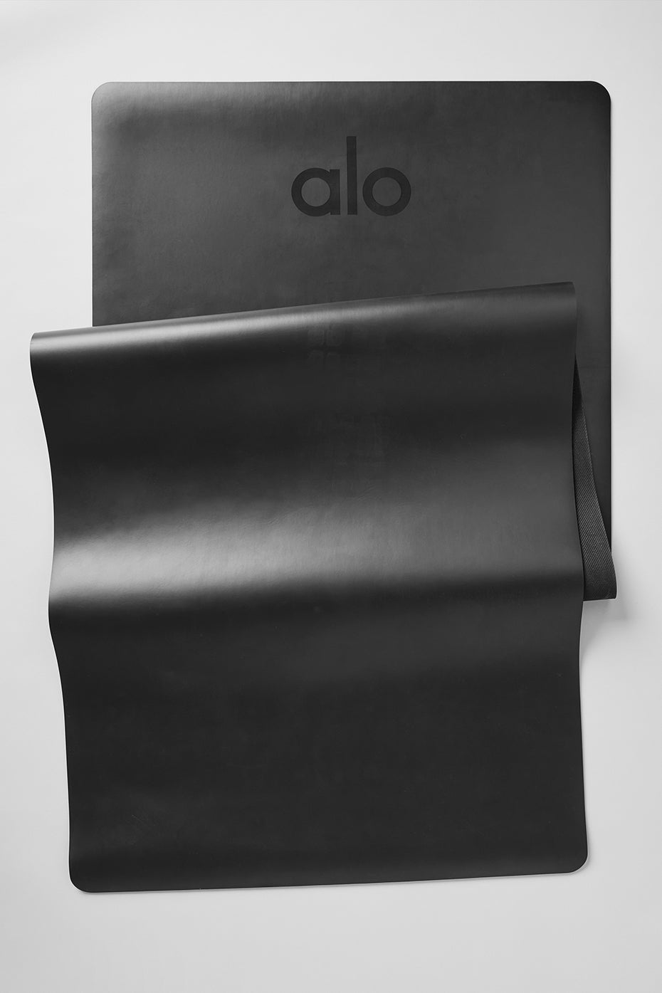 Top view of the Lighter Warrior Yoga Mat in black, showcasing its lightweight design.