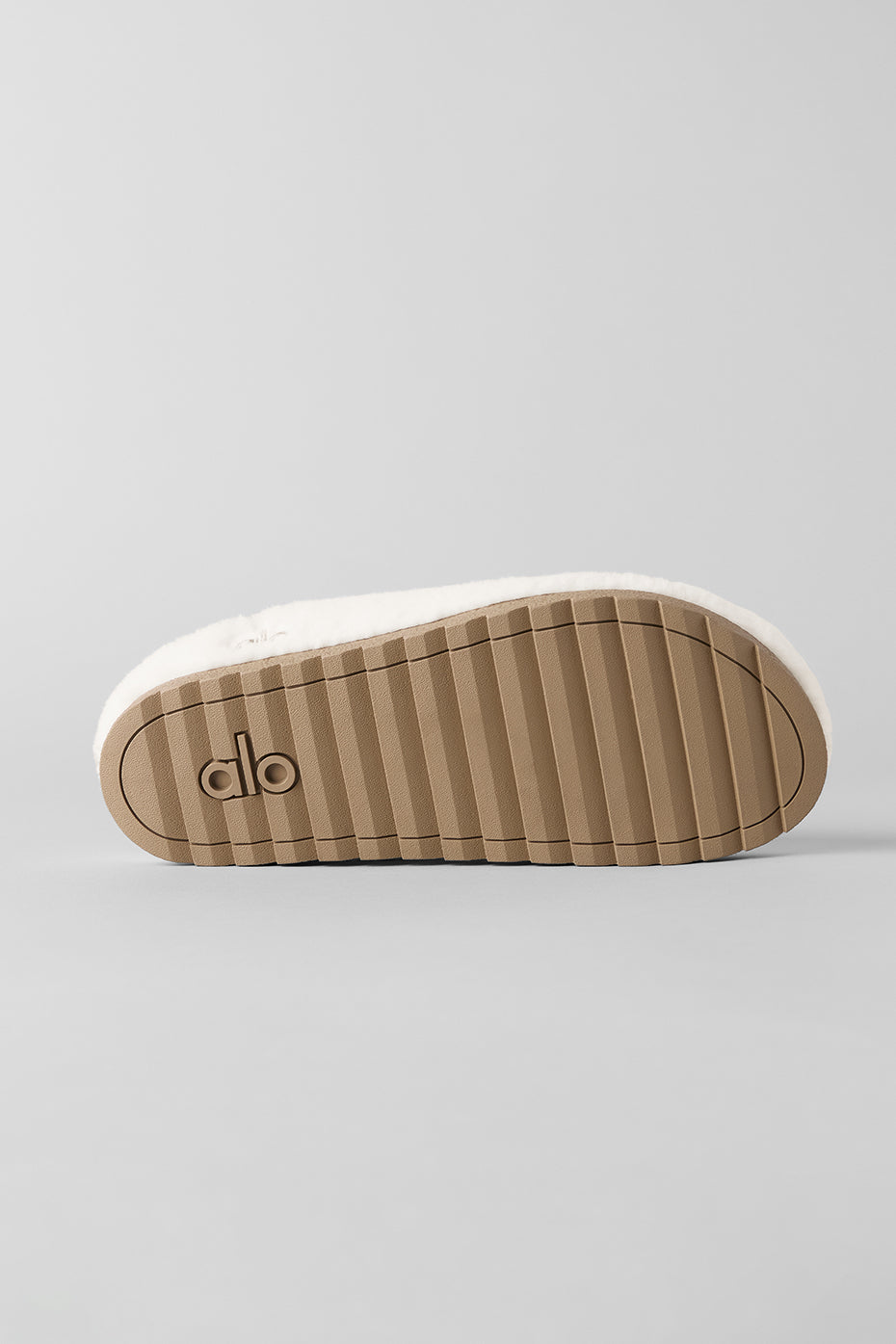 Orthopedic slippers for ladies next to yoga mat in a sunlit room