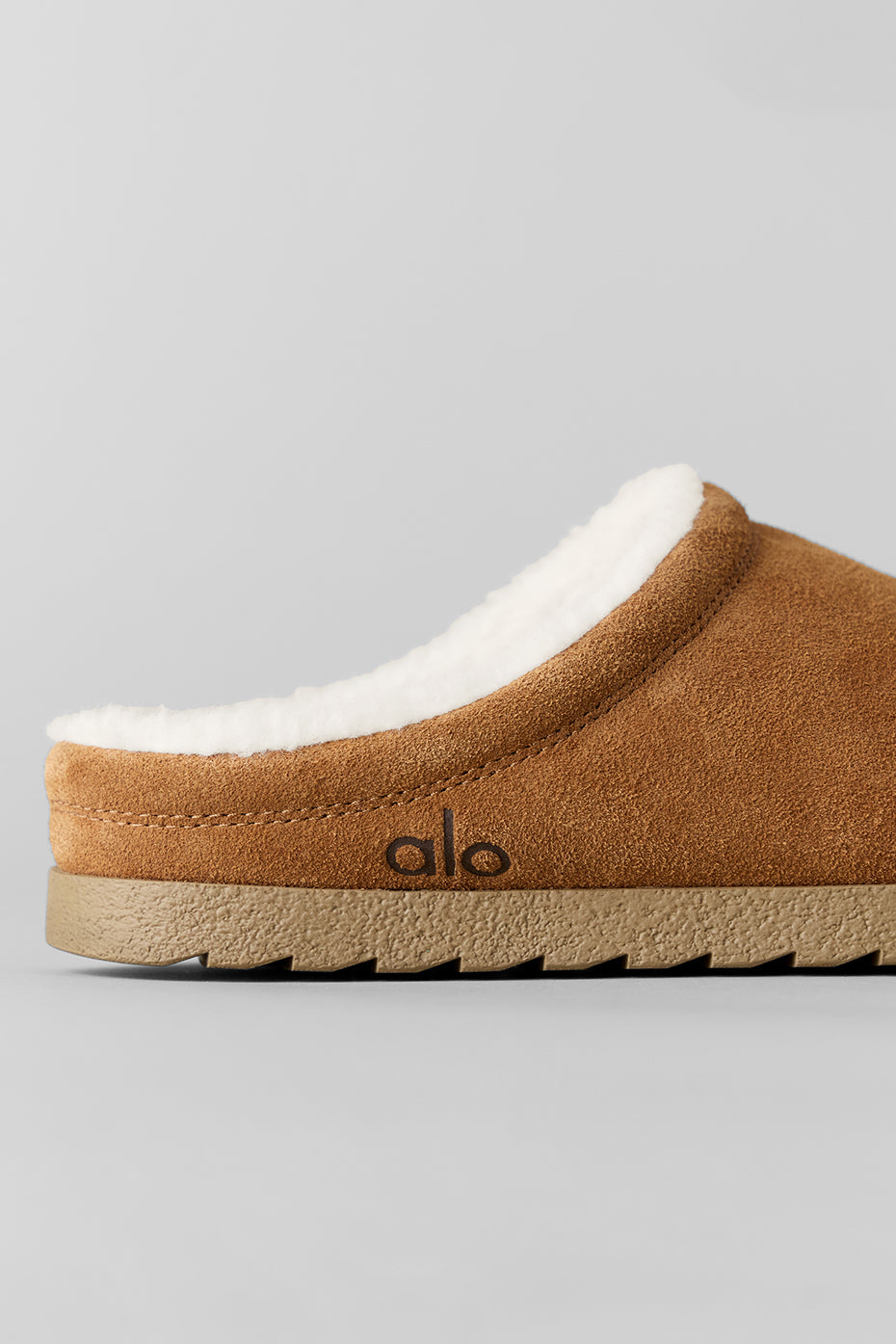 Saddle/ivory slippers paired with cozy socks for home relaxation
