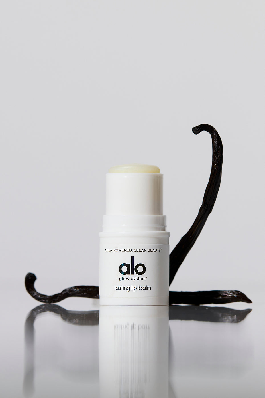 Application of moisturizing lip balm on dry lips outdoors.