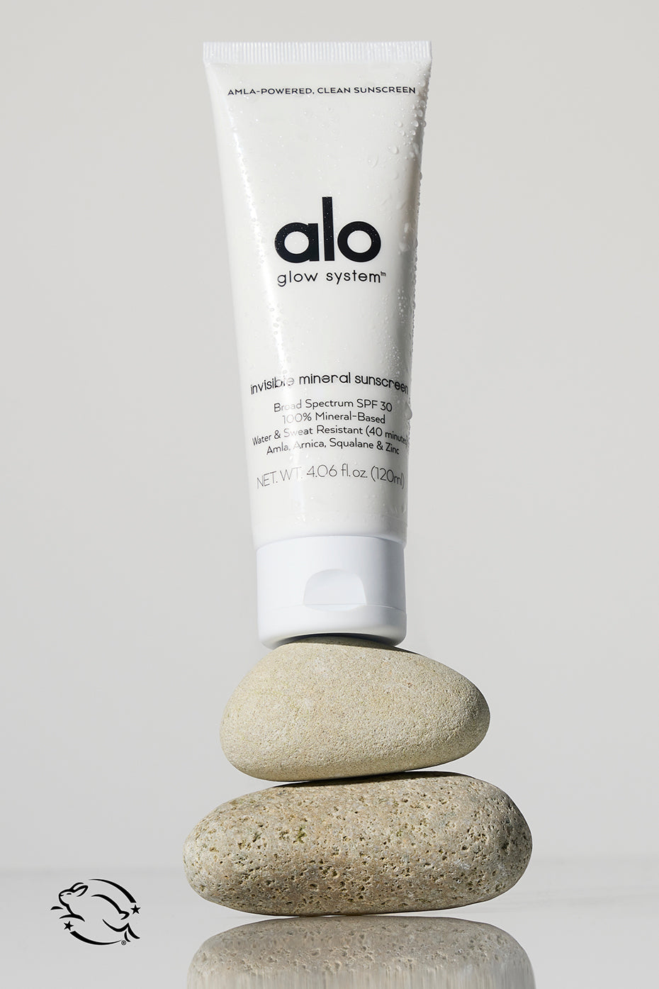 Invisible Mineral Sun Shield SPF 30 bottle on a sunny beach.
