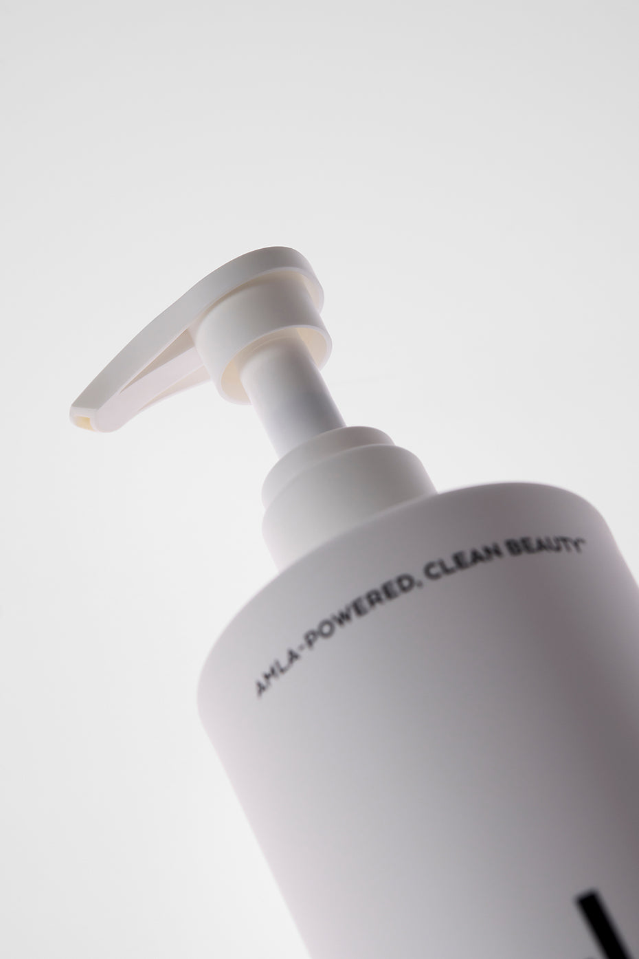 Magnesium stress relief body wash bottle in a serene bathroom setting.
