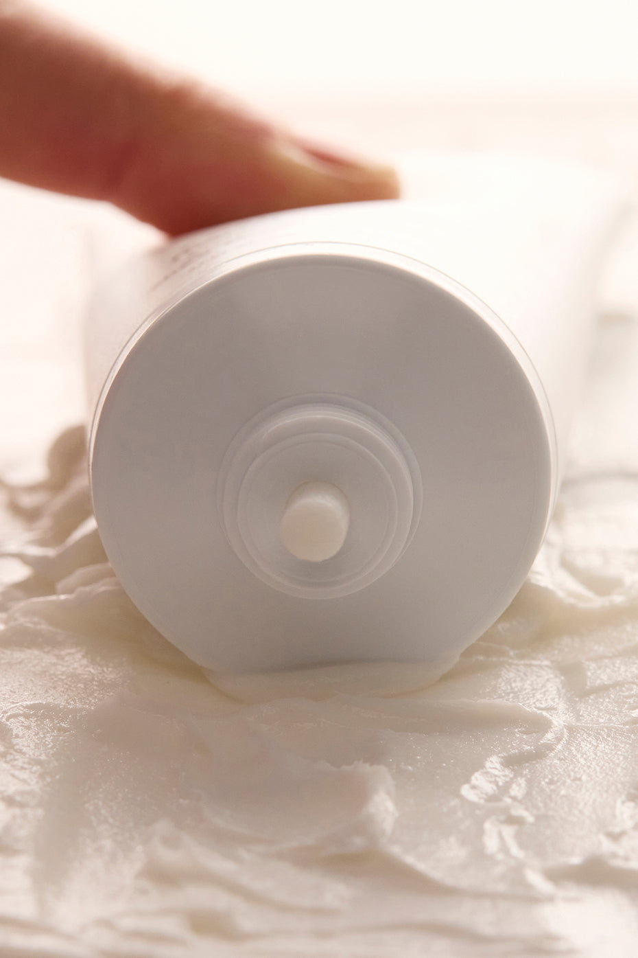 Sustainable tube of vegan hand cream on a wooden surface.