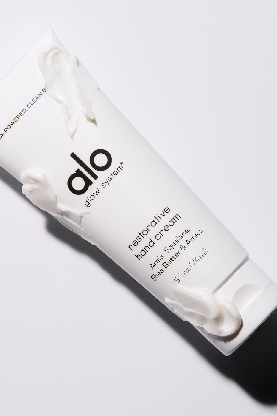 Close-up of nourishing hand cream tube against a clean background.