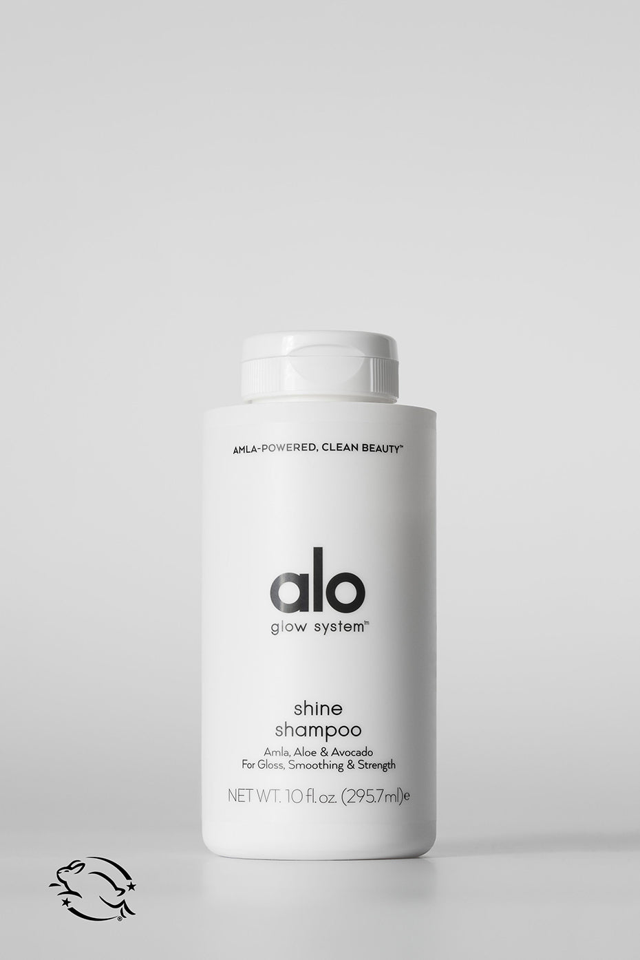 Bottle of vegan shine shampoo with botanical oils shown in daylight