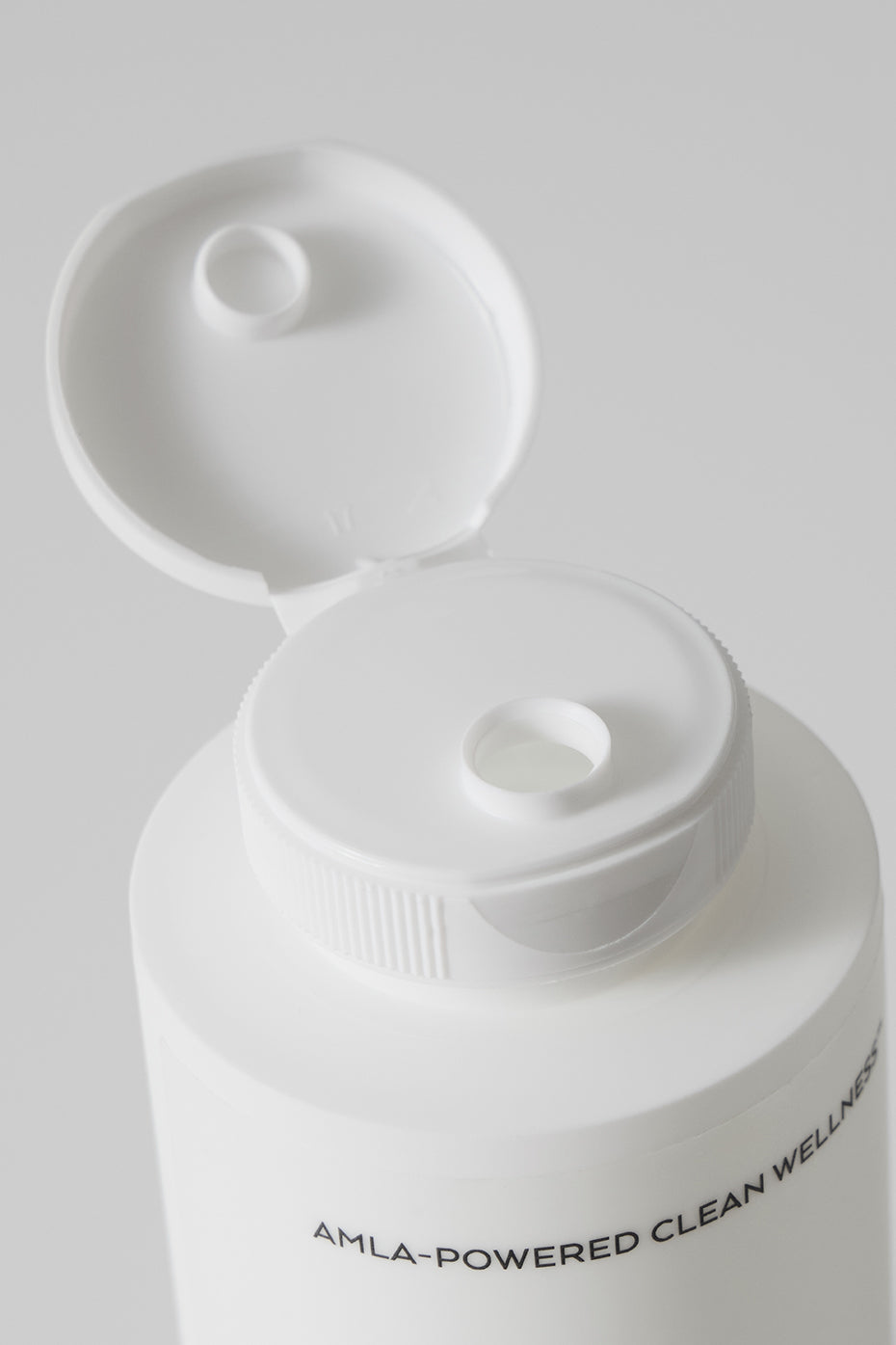 Vibrant Shine Conditioner displayed with fresh grapefruit, emphasizing its natural ingredients.