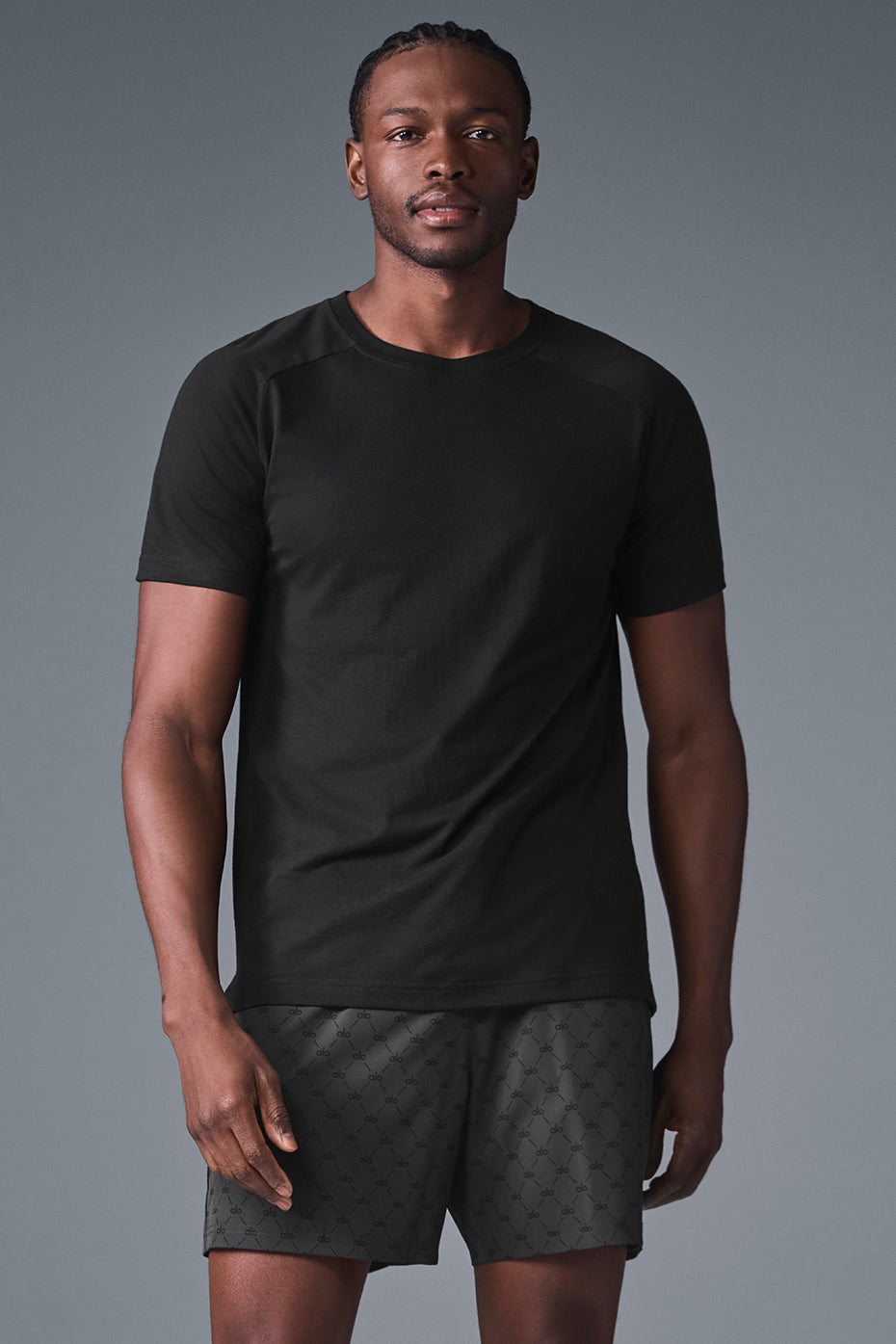 Triumph Black Raglan Tee on a mannequin, highlighting its soft fabric and crew neck design.