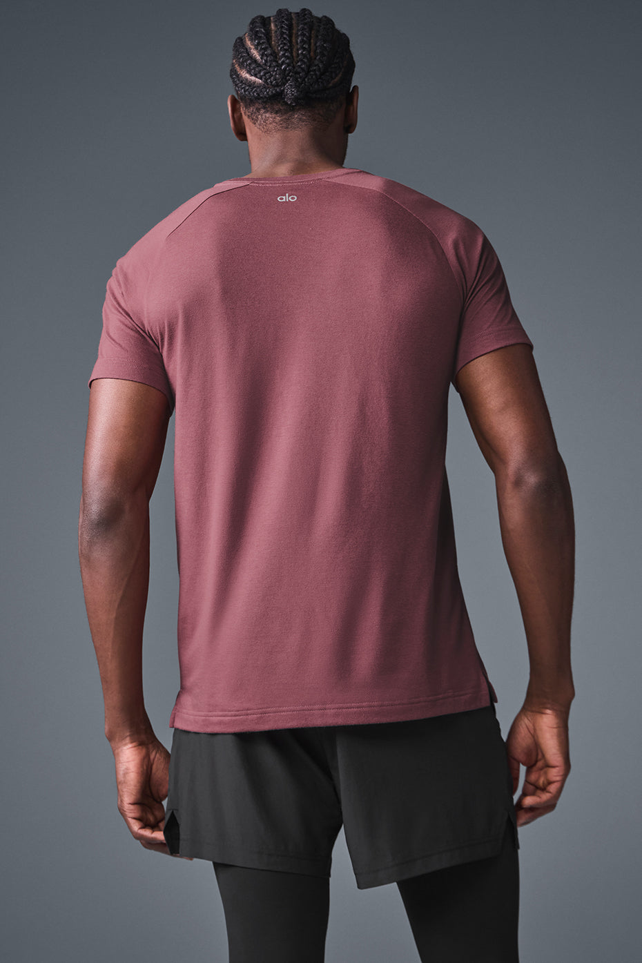 Side view showing the tailored cut of the burgundy polo t shirt styled with denim