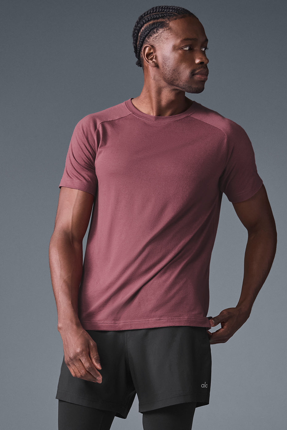 Model wearing slim fit burgundy t-shirt with raglan sleeves in outdoor café setting
