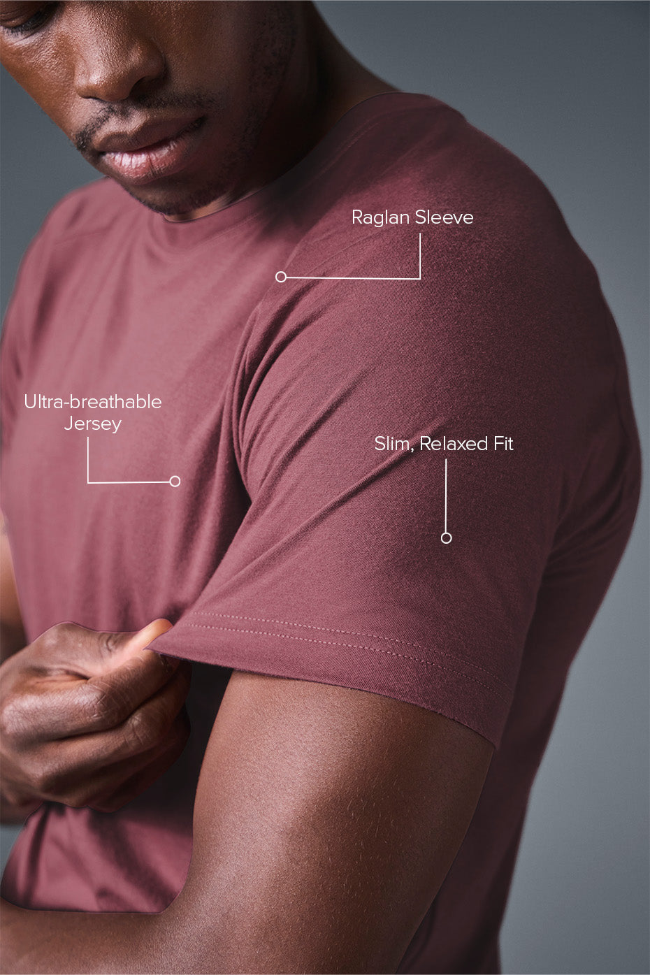 Flat lay of mens burgundy t shirt with crew neck and folded sleeves on rustic wood table
