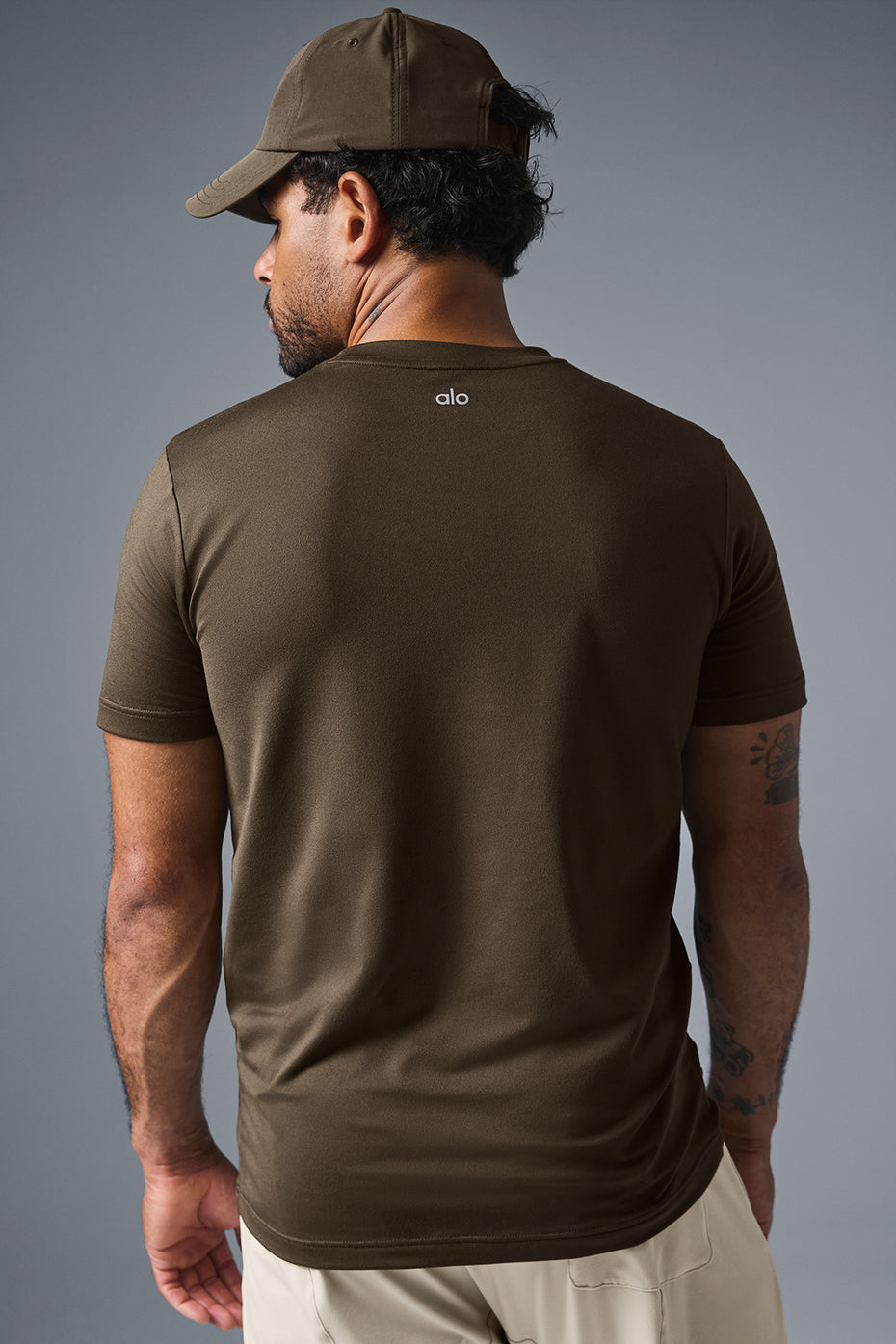 Model wearing short sleeve baseball tee in casual street setting