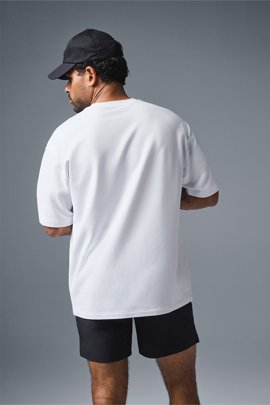 Side view of the comfortable oversized t-shirt, showcasing its extended sleeves.