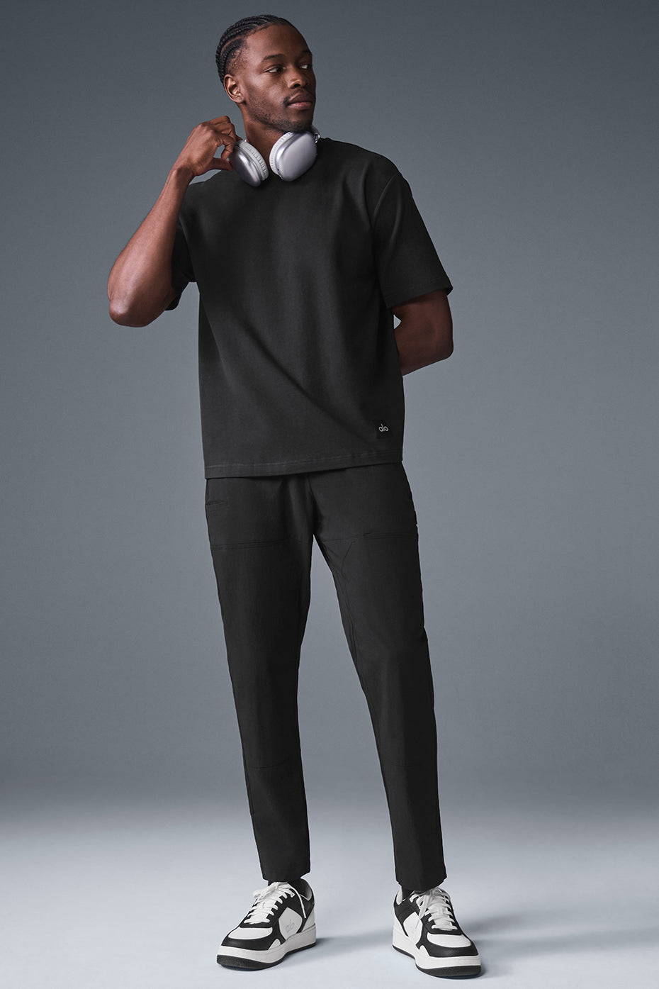 Model wearing the oversized tee with cargo pants, showcasing extended sleeves and hem