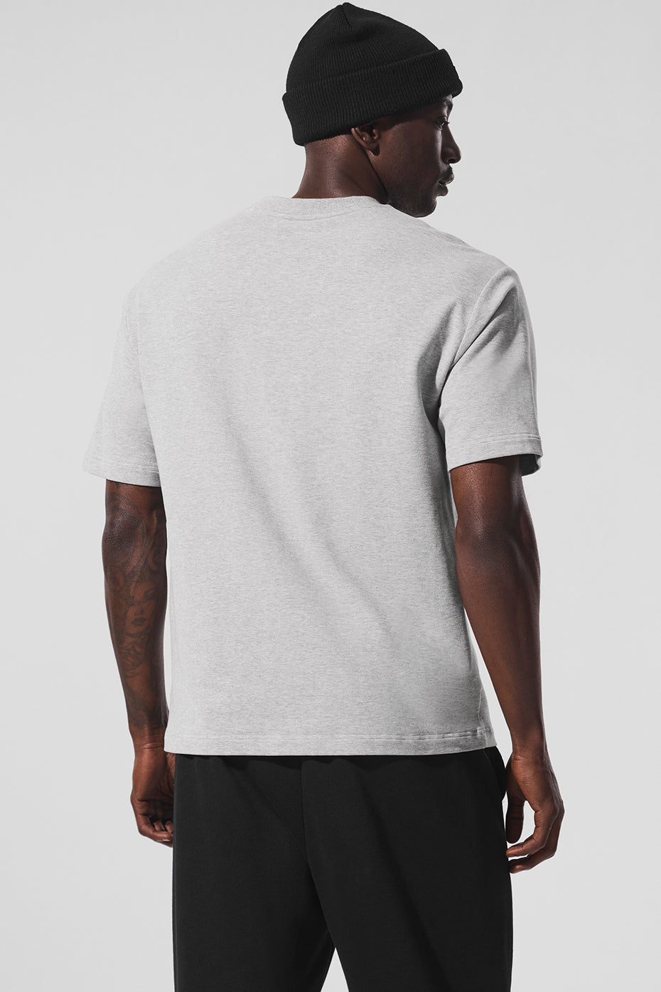Side view showcasing the extended sleeves of the oversized t-shirt.