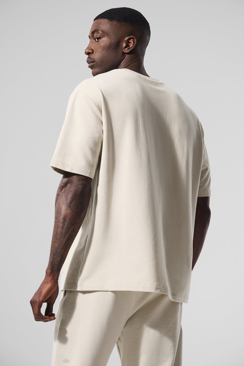 Model wearing the oversized tee paired with cargo shorts, showcasing relaxed fit