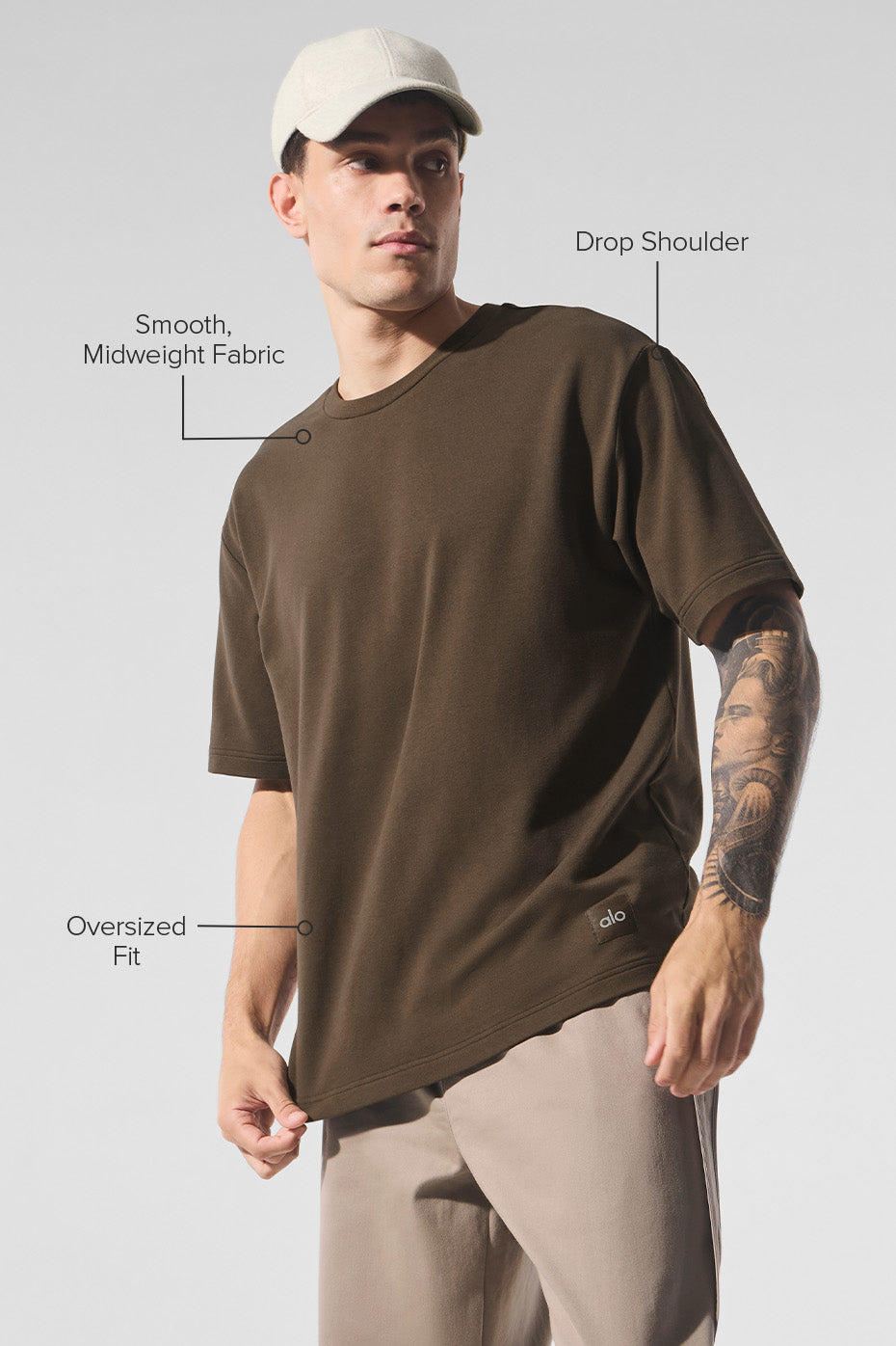 Side angle of the oversized t-shirt showcasing its extended sleeves.