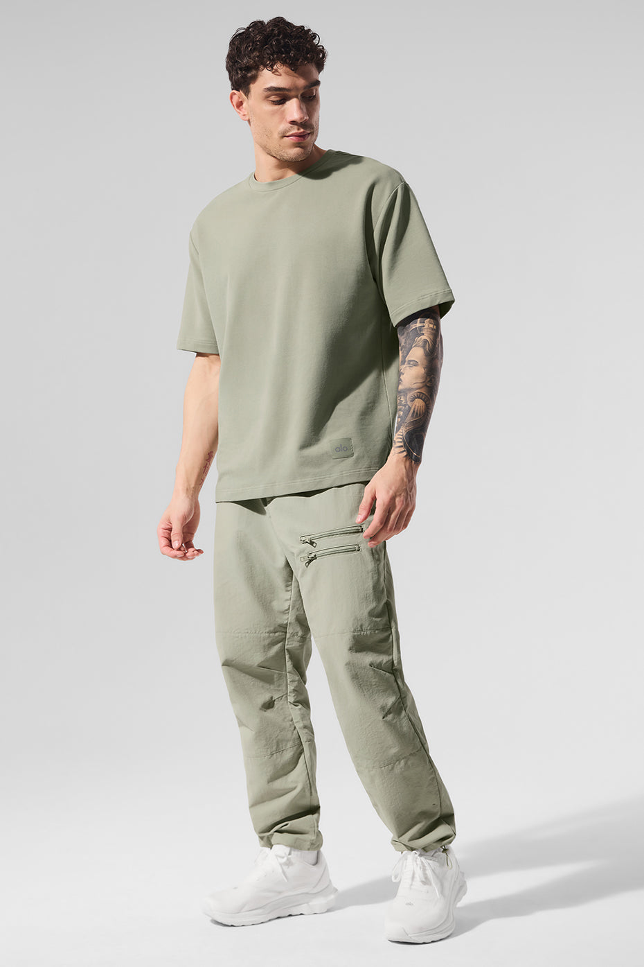 Front view of the oversized t-shirt in limestone showing extended sleeves