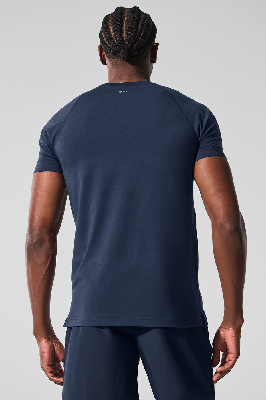 Side profile of activewear tee paired with joggers on a post-gym coffee run
