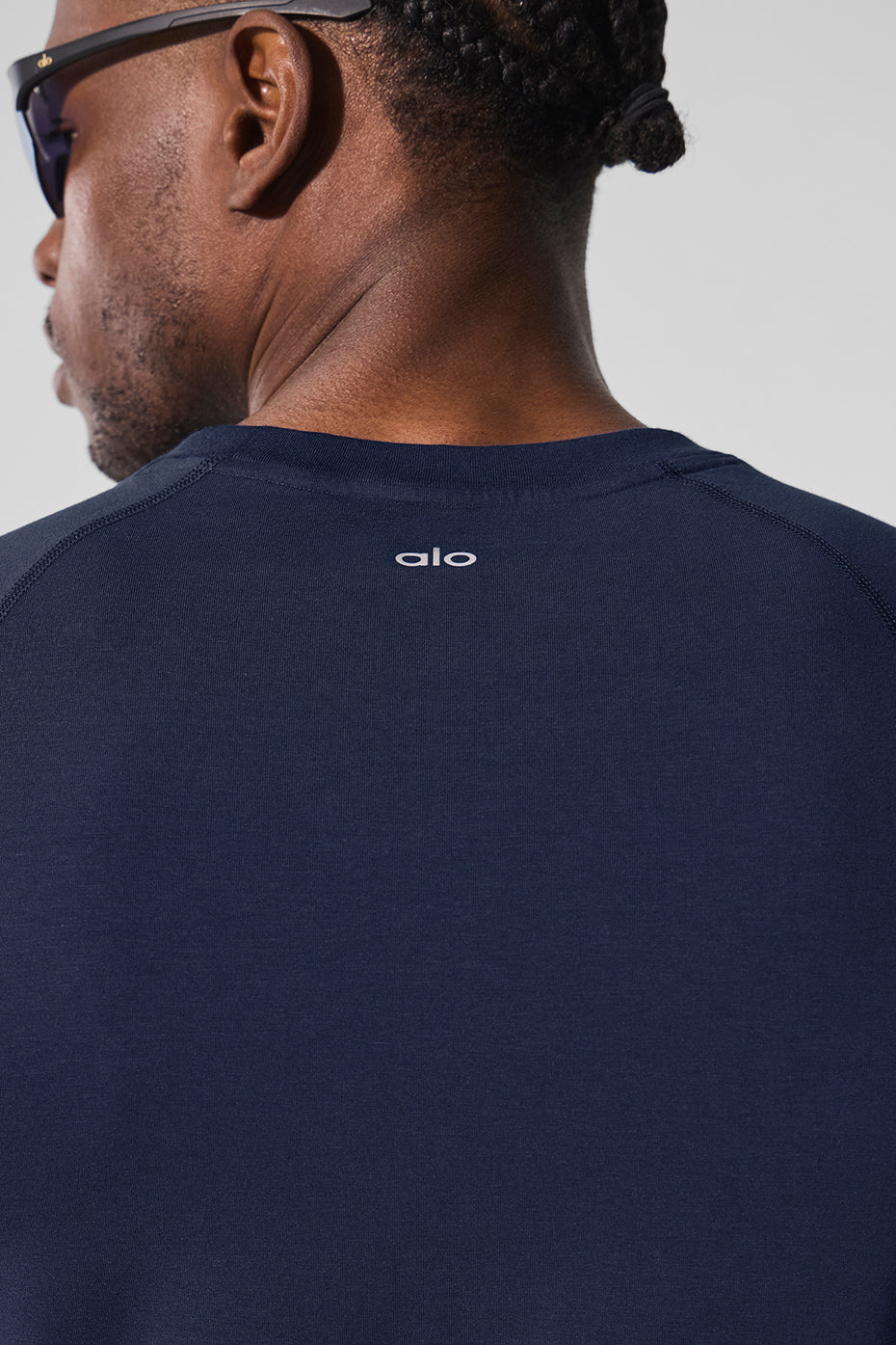 Detail angle showing crew neckline and breathable fabric texture for gym clothing