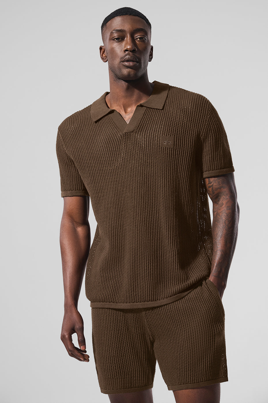 Espresso open-knit golf polo showcasing V-neck design on the course.