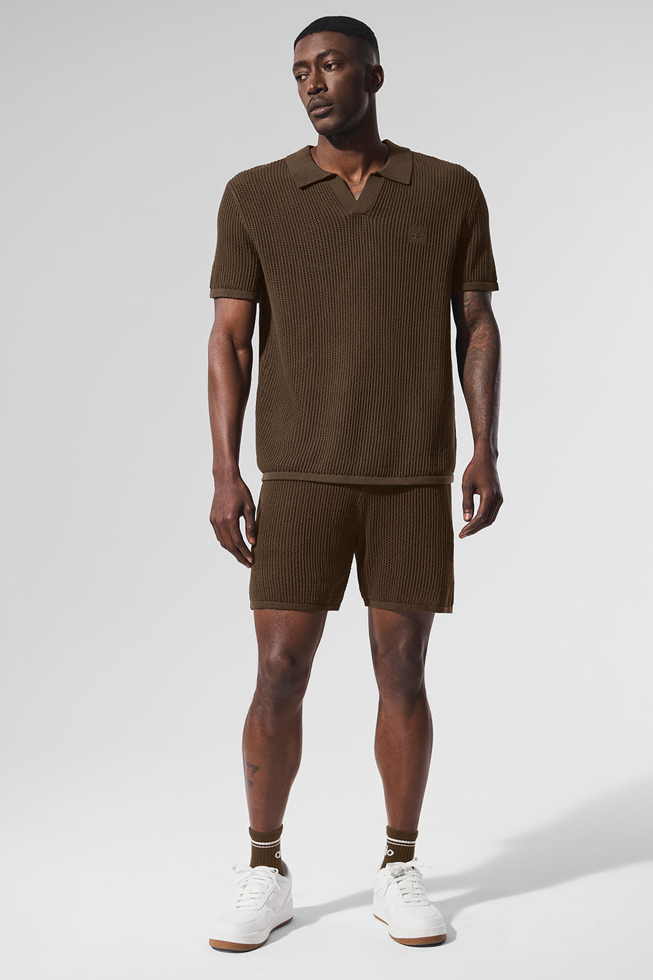 Espresso open-knit golf polo showcasing V-neck design on the course.