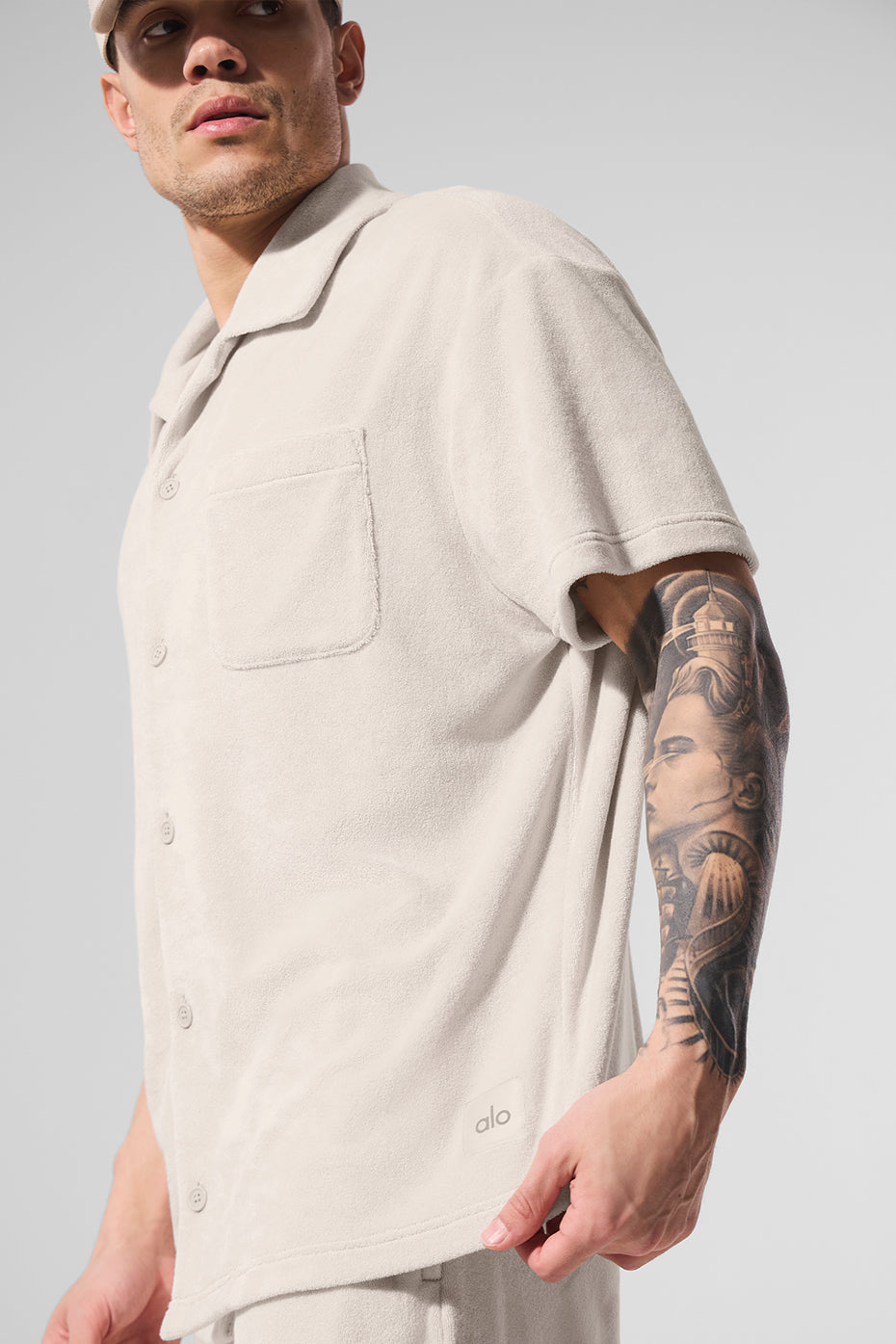 Model wearing Coastal Terry Button-Up shirt in summer setting, demonstrating relaxed fit.