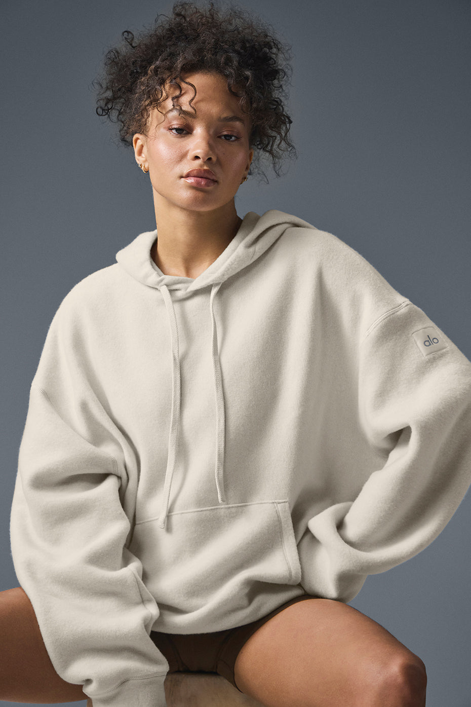Close-up of the Triumph Restore Hoodie’s fleece texture and kangaroo pocket.