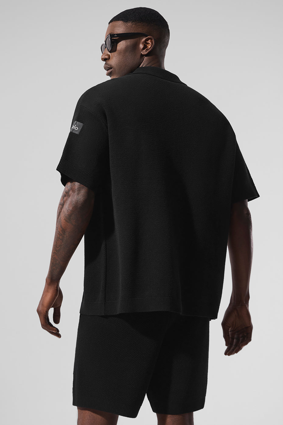 Styled outfit featuring black short sleeve button-up sweater for evening wear