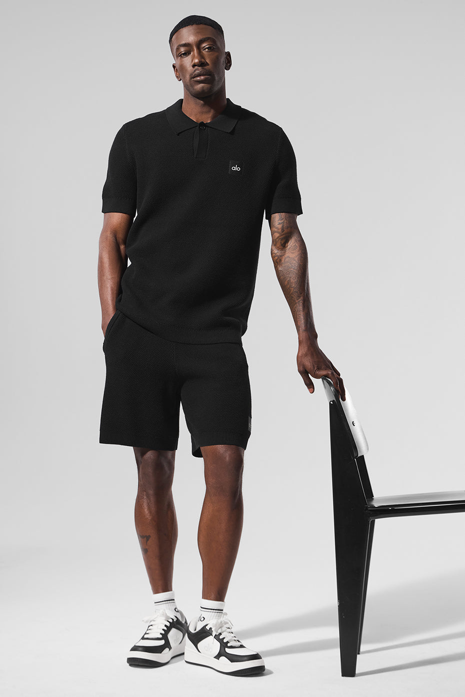 Front view of the black polo shirt, ideal for golf apparel.