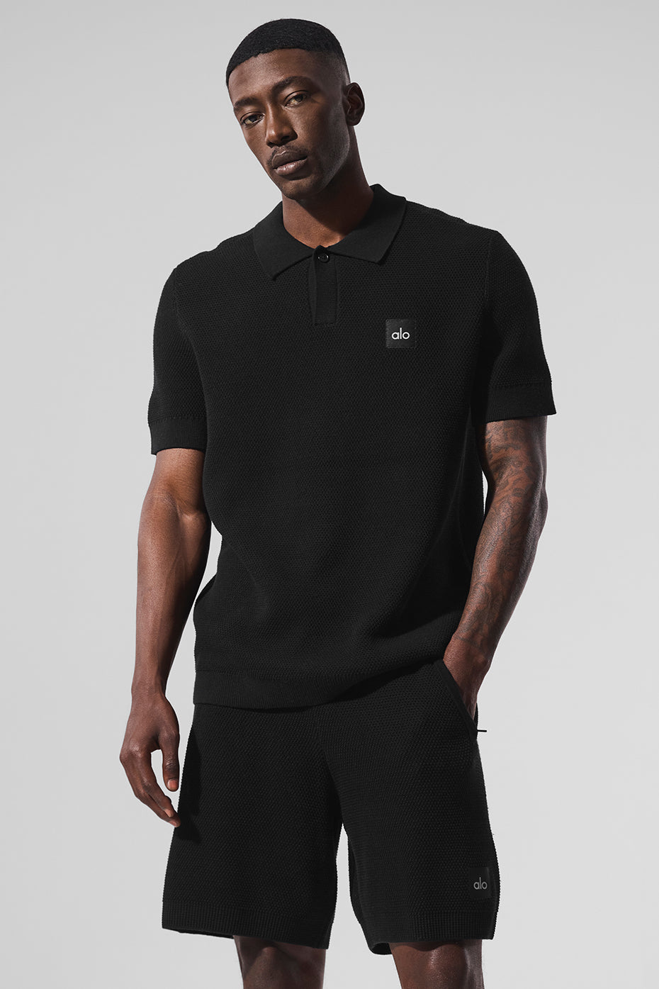 Front view of the black polo shirt, ideal for golf apparel.