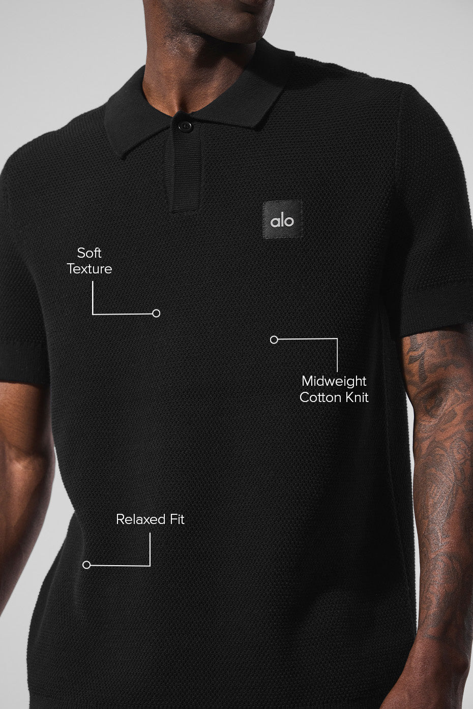 Model wearing the black polo shirt on the golf course.