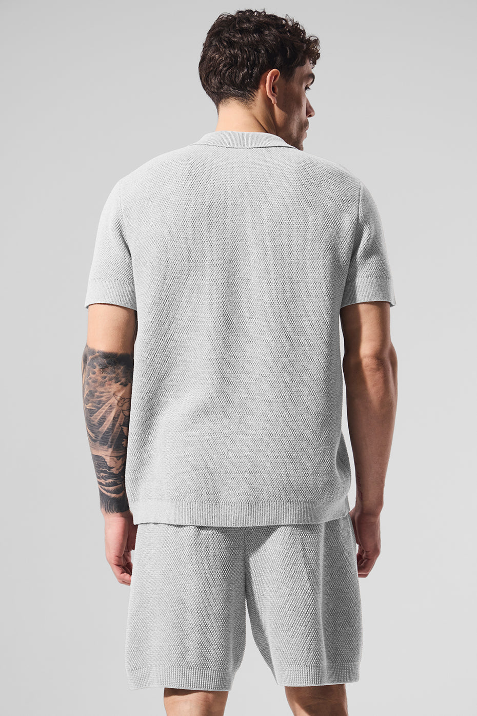 Model wearing the knit polo shirt paired with matching shorts.