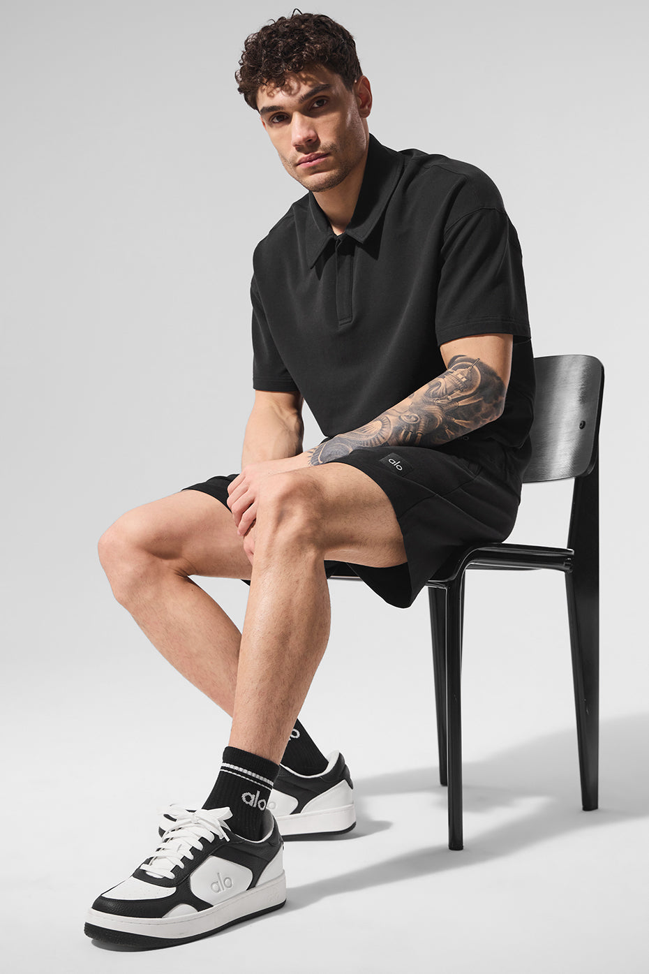 Close-up of the black polo shirt showcasing its fabric.