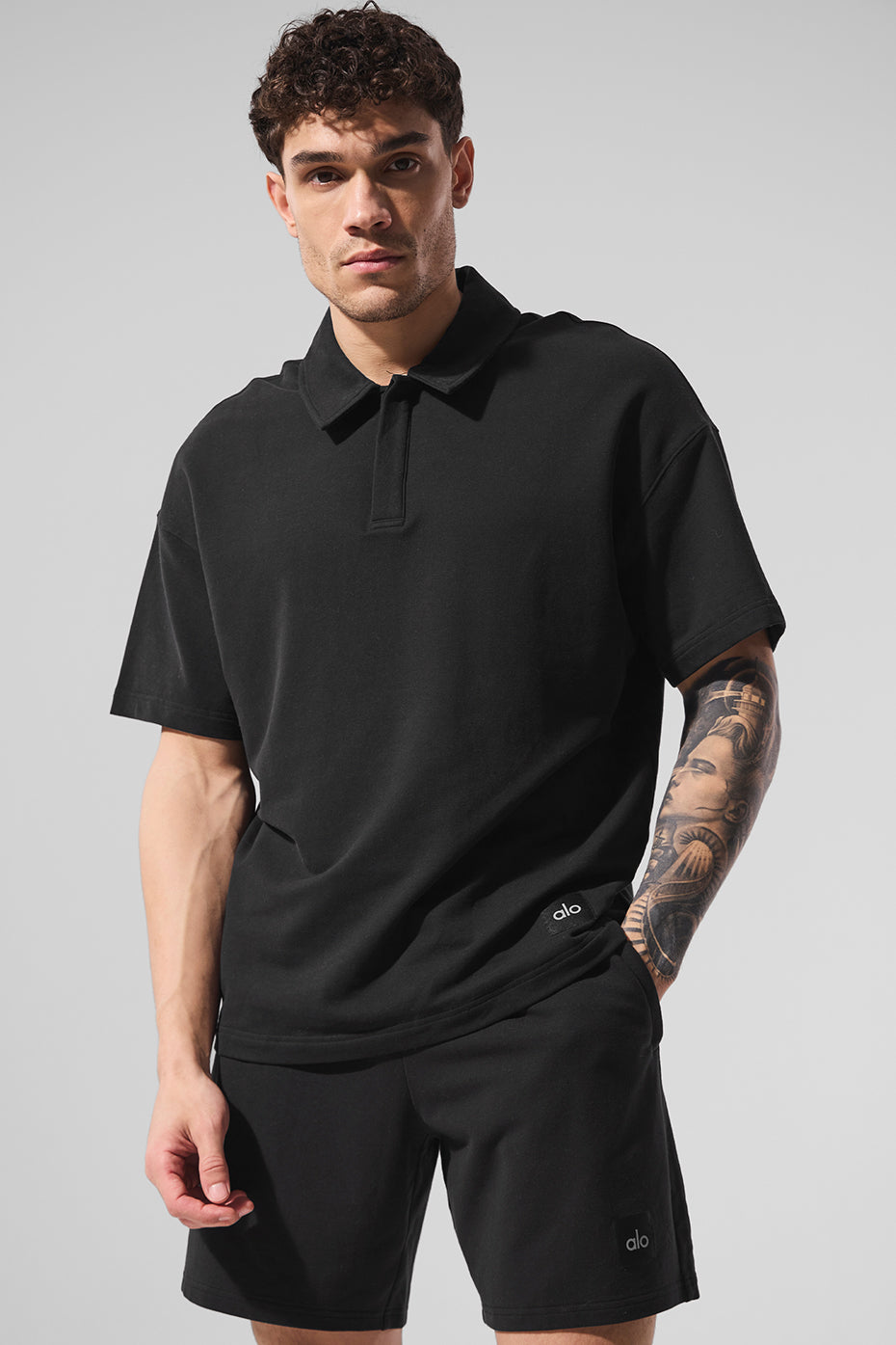 Men wearing black polo shirt on the golf course.