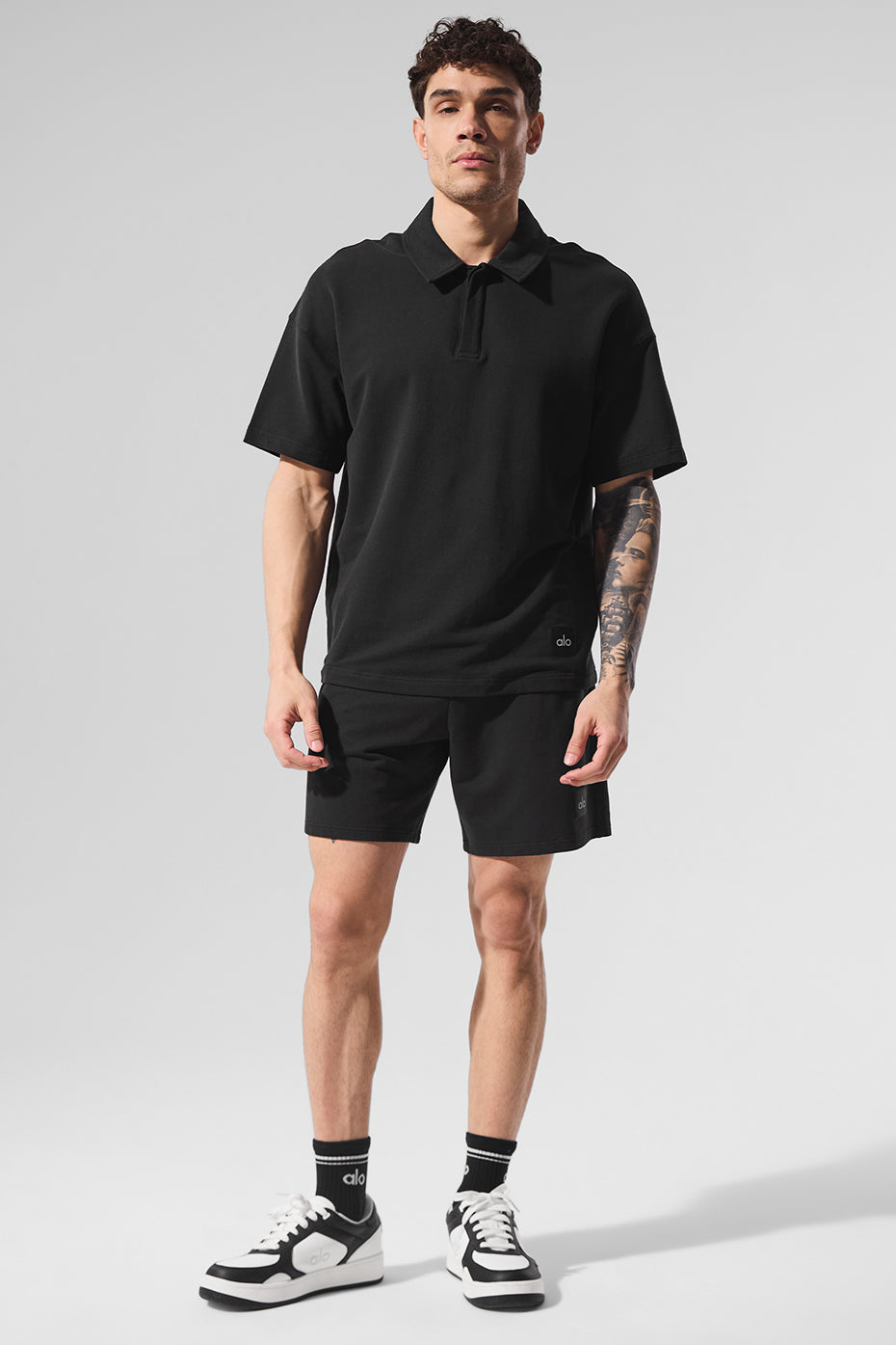 Men wearing black polo shirt on the golf course.