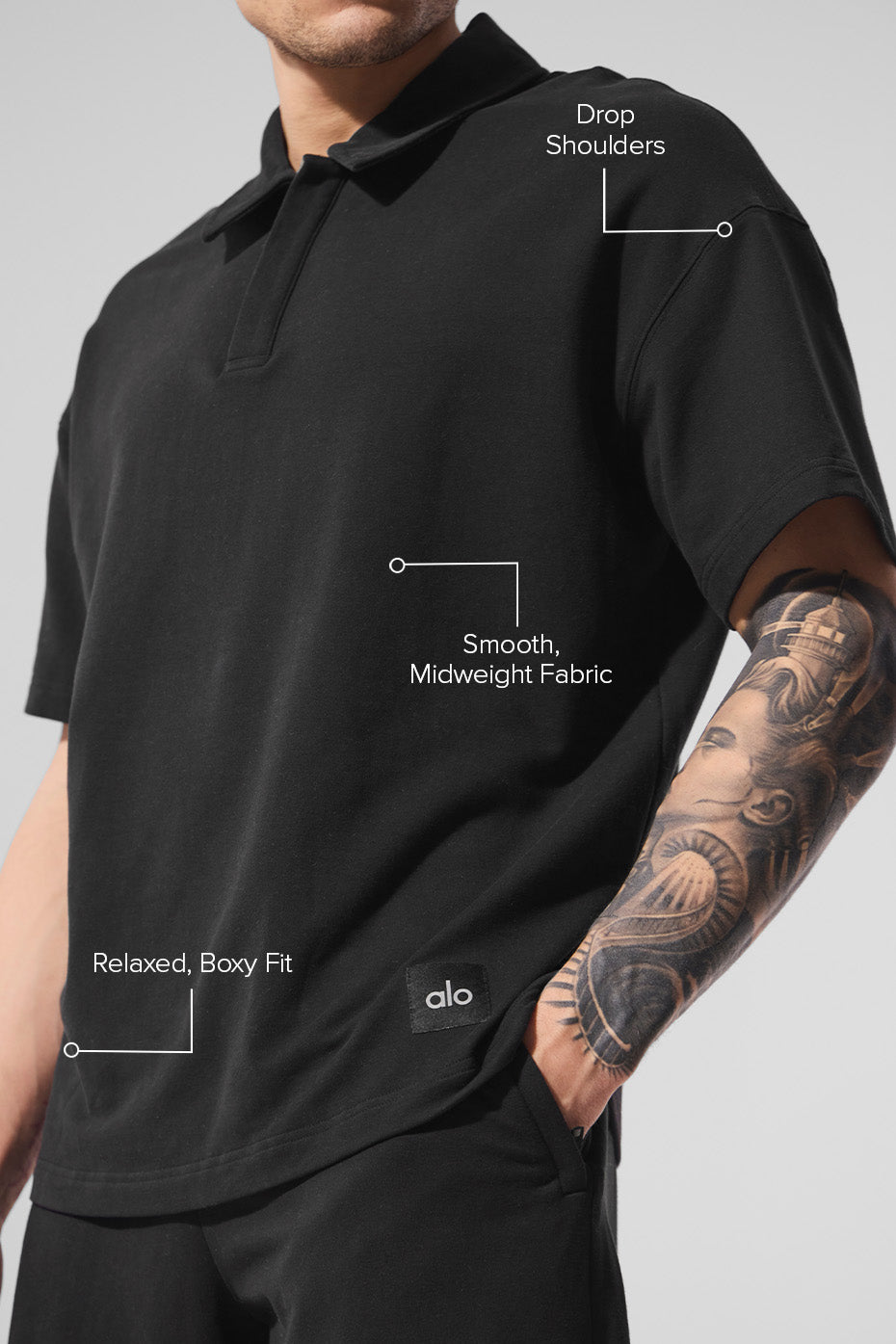Close-up of the black polo shirt showcasing its fabric.