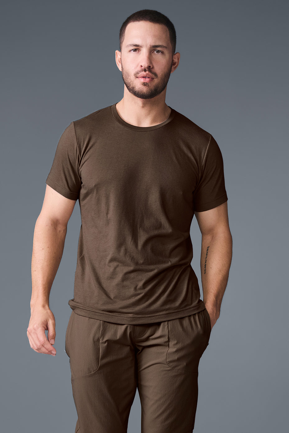 Front view of espresso fitness t-shirt styled with plus size workout clothes outdoors.