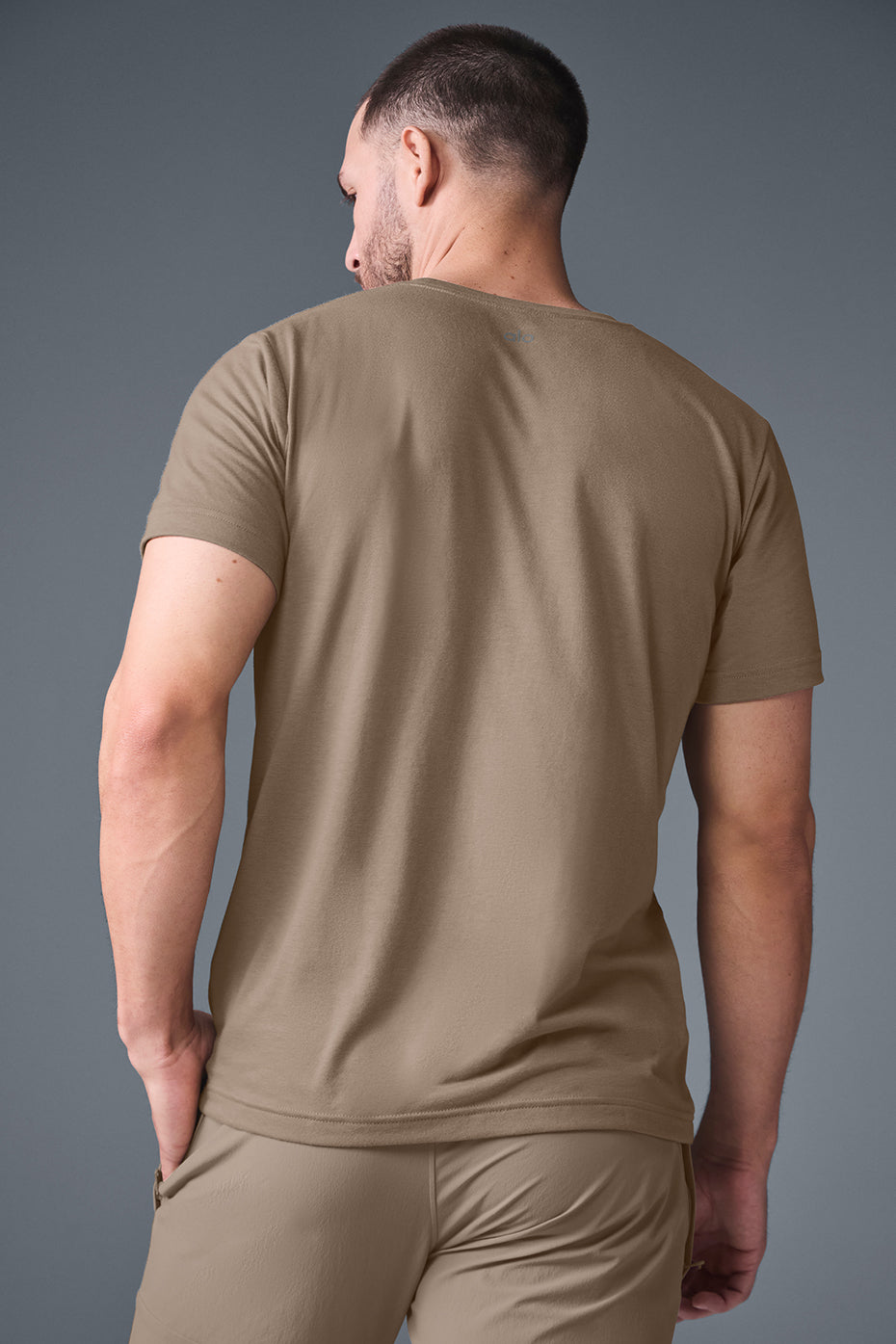 Casual scene with a woman wearing the Triumph fit t-shirt while relaxing outdoors