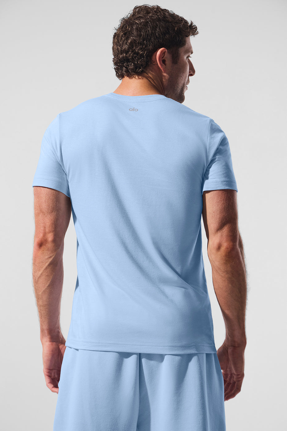 Lifestyle shot of the Triumph Tee styled with activewear dresses post-recovery.