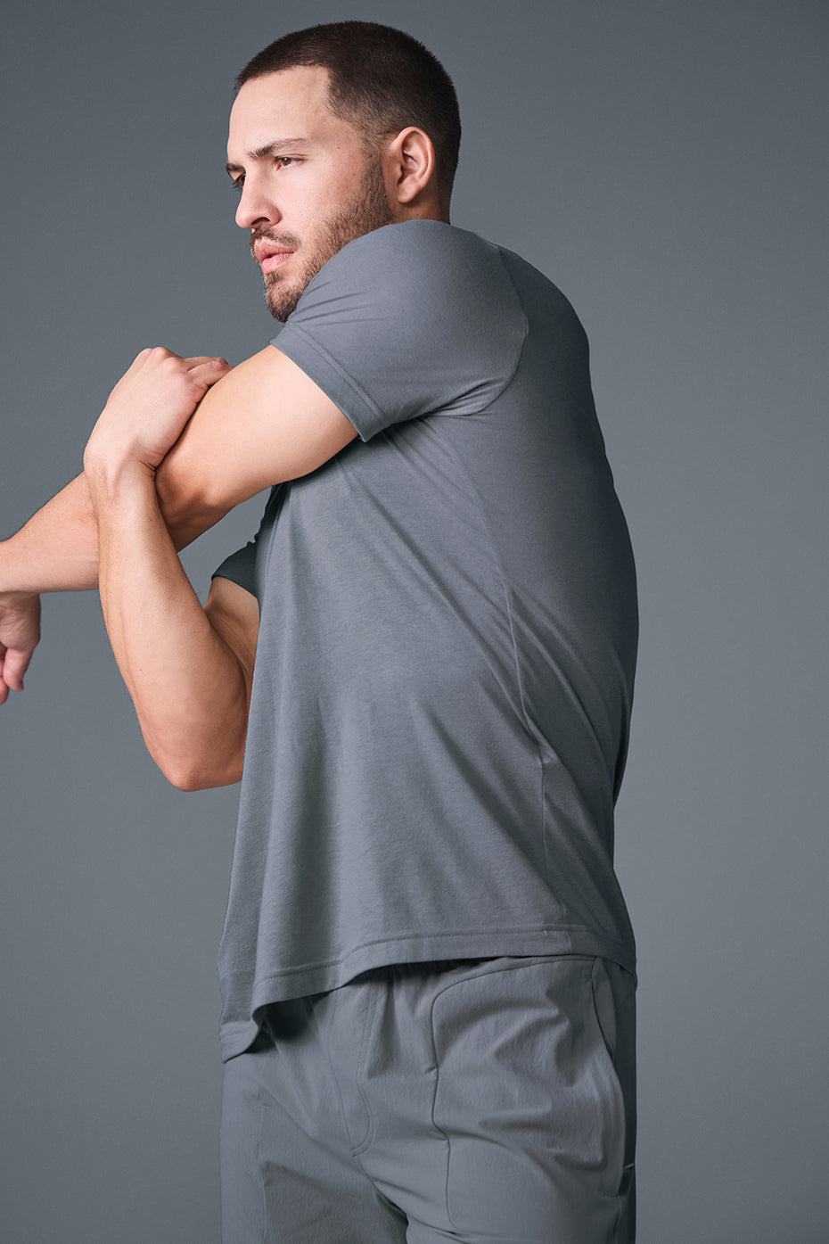 Man showcasing the Triumph Performance Tee in Steel Grey from the front during a workout.