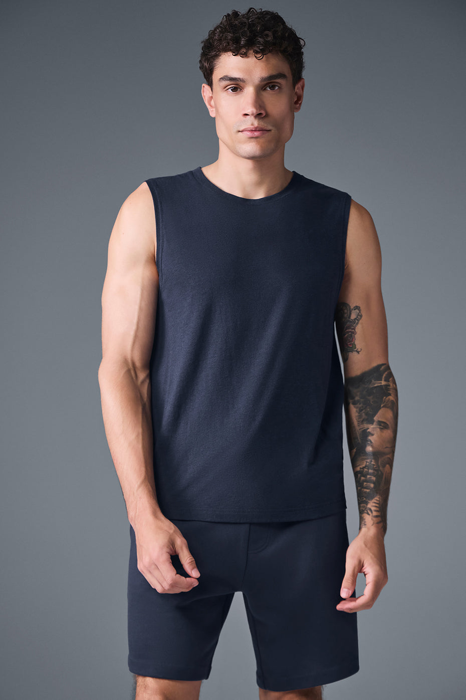 Front view of the Triumph Muscle Tank in navy blue, showcasing its relaxed fit.